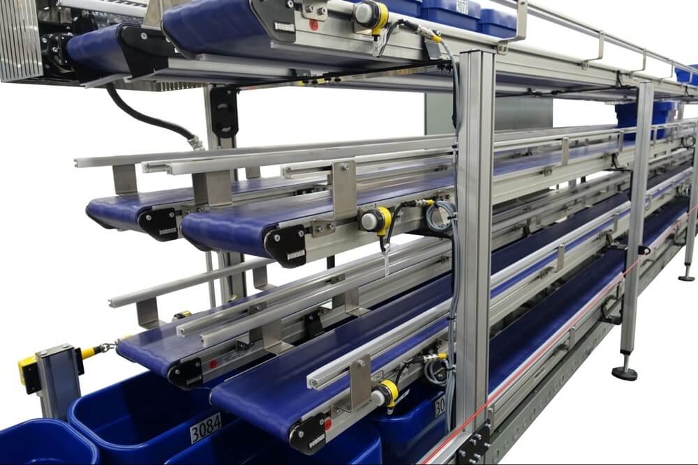 A Dorner 2200 series conveyor with totes for pharmaceutical and nutraceutical applications.
