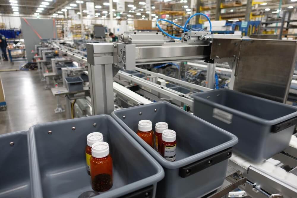A Dorner conveyor tote system for transporting bottles of pharmaceutical or nutraceutical products.