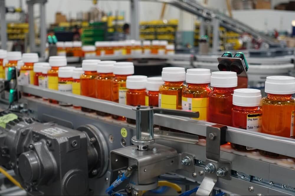 Bottles of prescription medications on a Dorner conveyor belt.